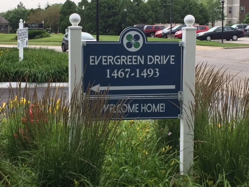 An image of a residential multifamily housing post and panel sign.